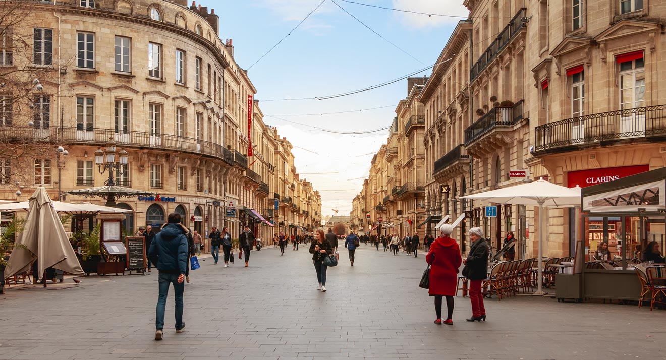 People walking down a street in the city of Bordeaux, France