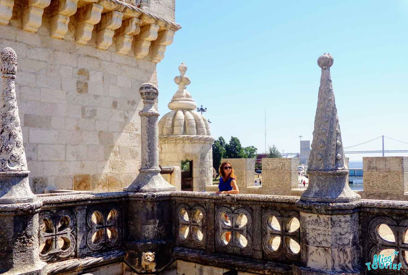 The writer of the article exploring the ornate Gothic architecture of the Tower of Belém in Lisbon, with stone carvings and the Tagus River in the background