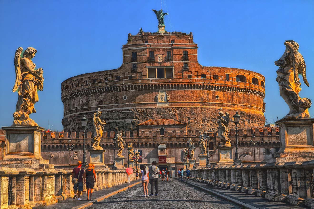 Castel Sant'Angelo in Rome with statues of angels lining the bridge leading to the entrance.