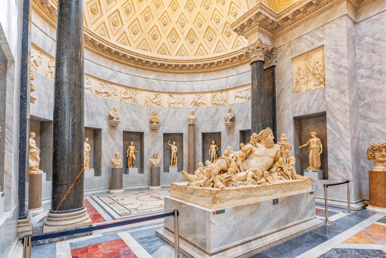 The intricate marble statues and opulent decorations inside the Vatican Museums.