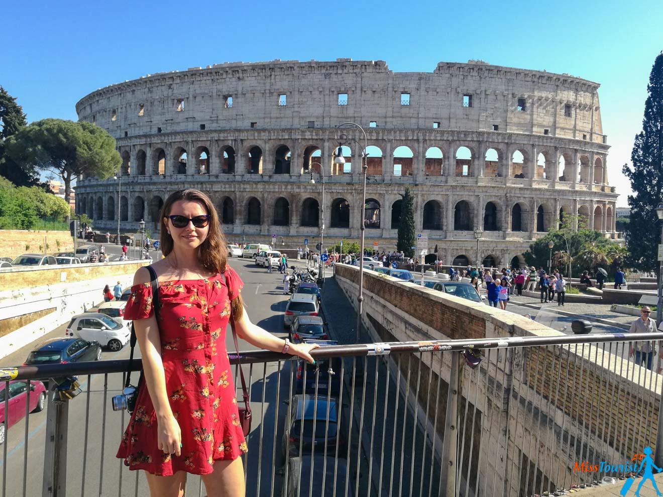 The author of the post in a red dress standing in front of the collision.