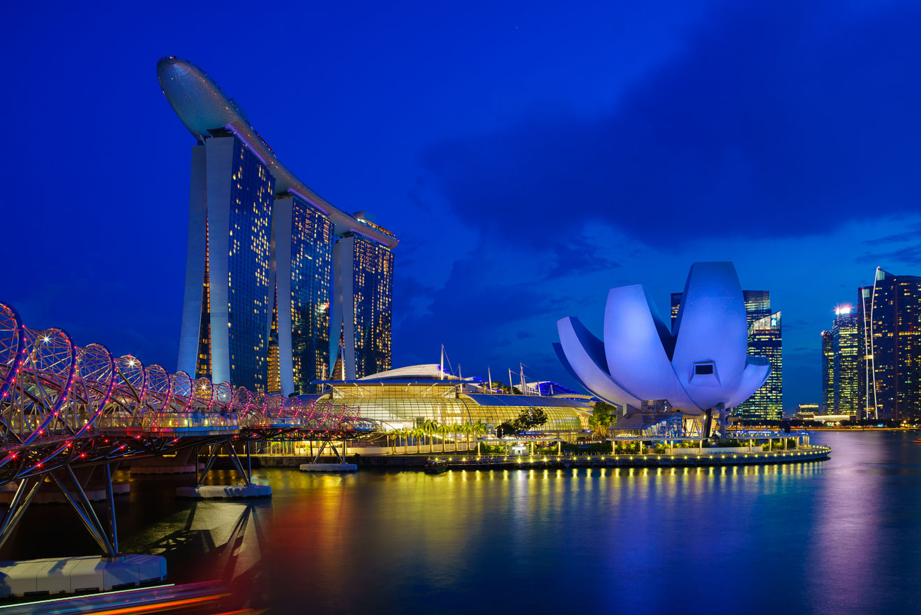 A picture of Marina Bay Sands Hotel in Singapore at night with some attractions around it