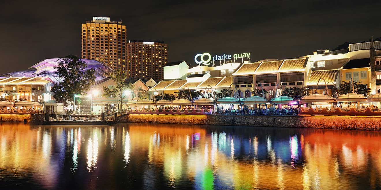 An image of Clarke Quay waterfront at night with restaurants 