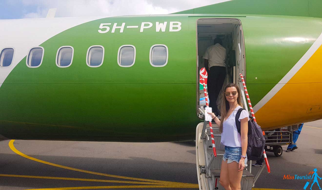 a girl boarding a green plane in Zanzibar