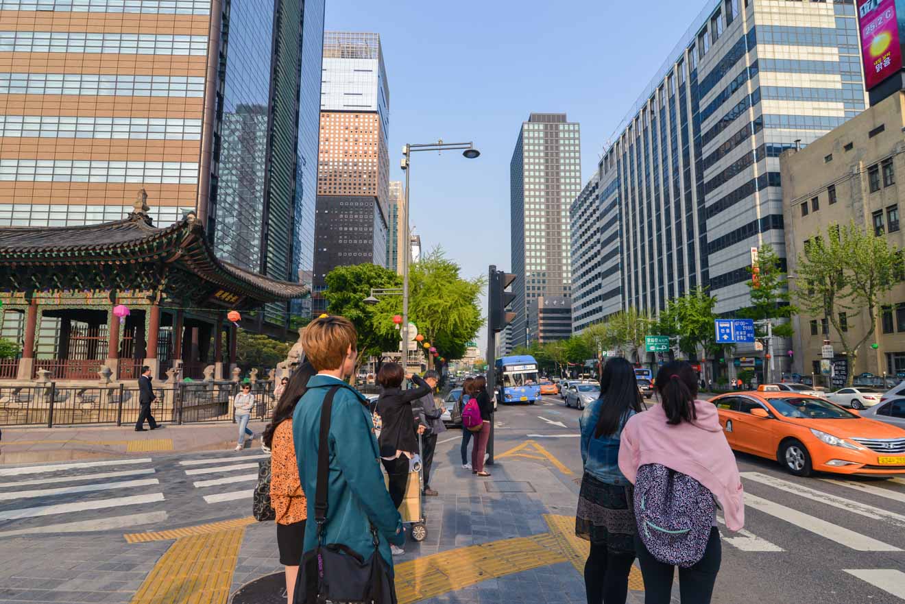 A group of people crossing a street in seoul, south korea.