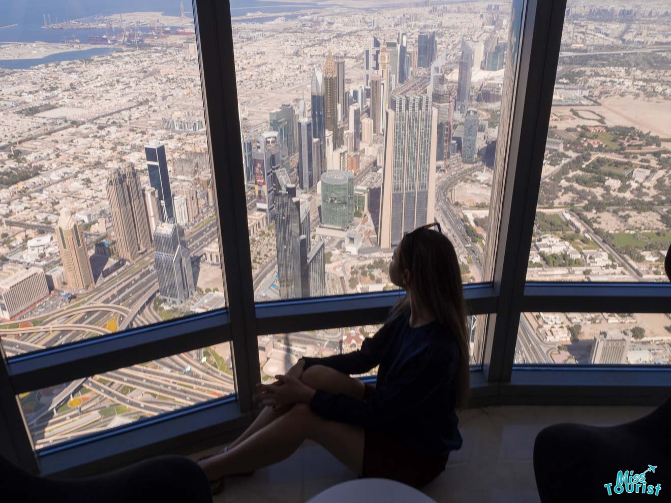 woman in front of burj khalifa window