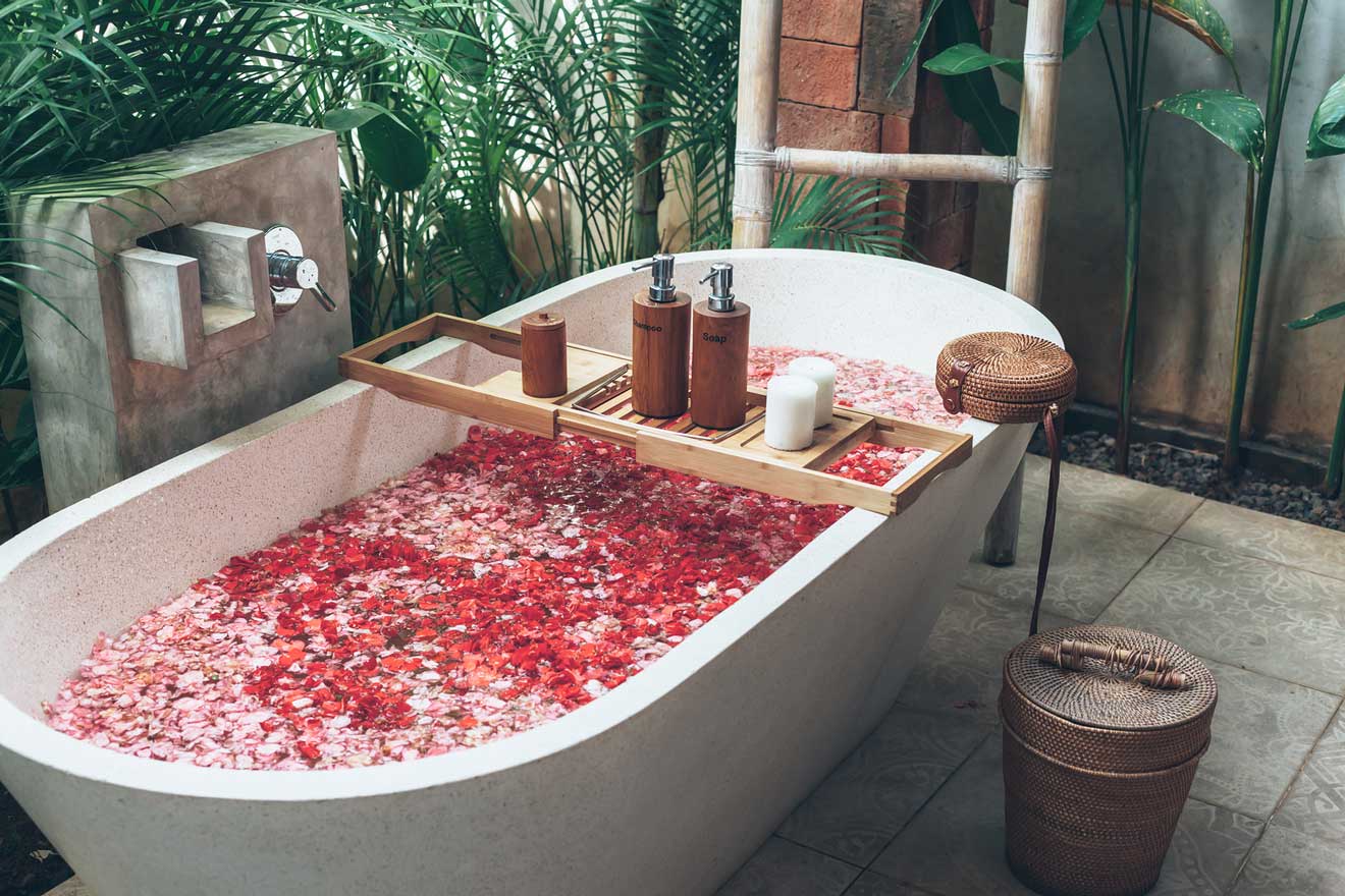 bathtub with rose petals in an outdoor bathroom