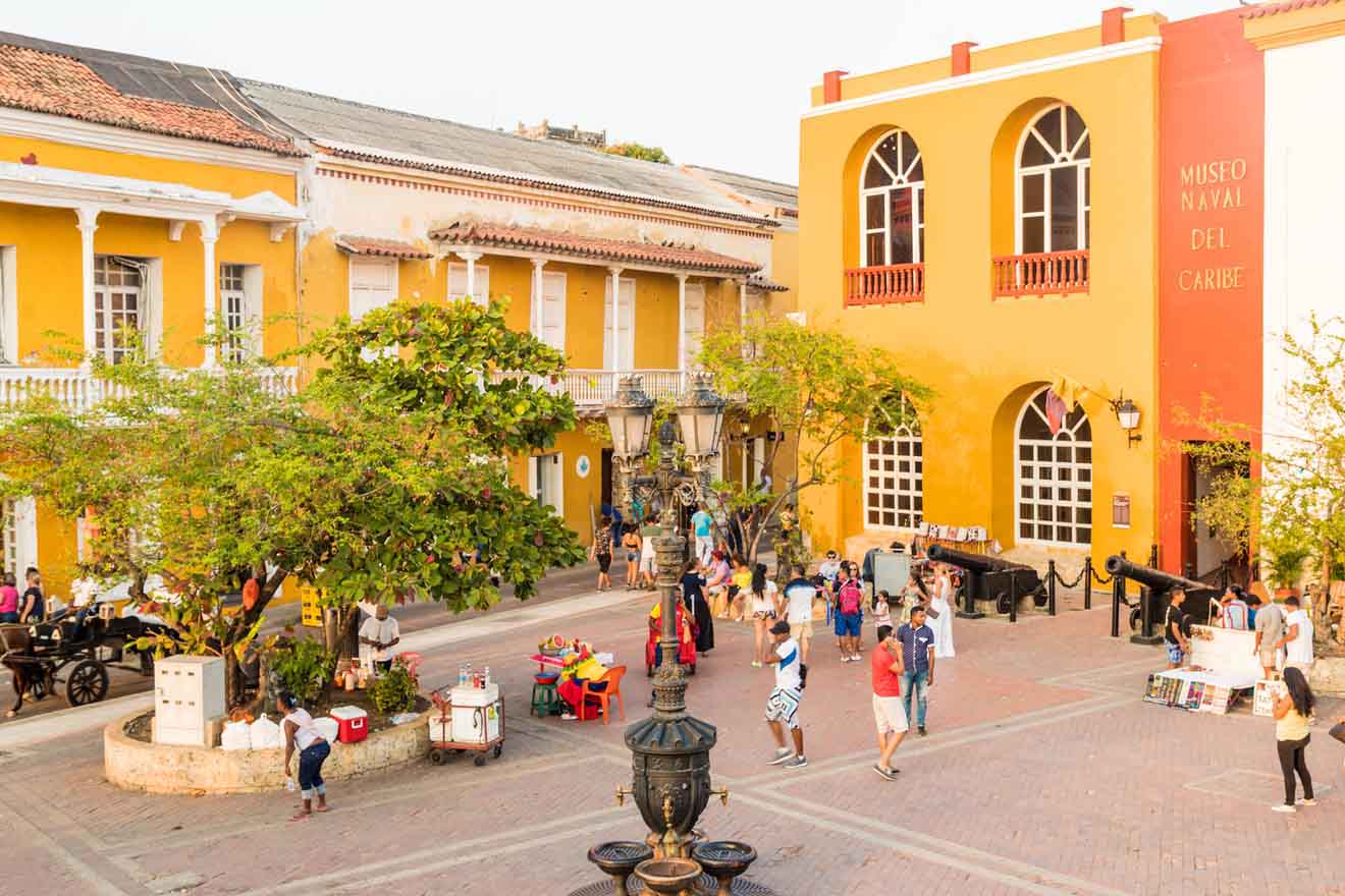 Bustling city square in Cartagena with pedestrians, street vendors, and colonial buildings, illustrating the vibrant public life and cultural richness of the area