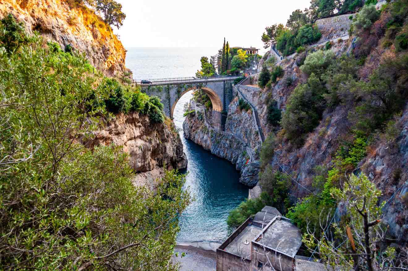 A bridge over a canal near a cliff in the city of Furore on the Amalfi Coast in Italy
