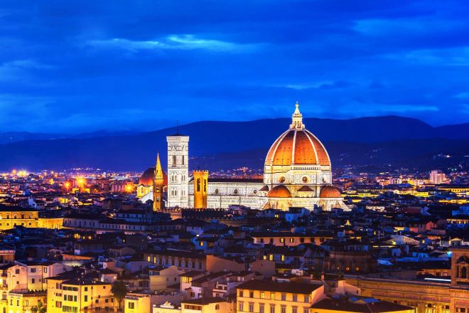 Florence's Cathedral of Santa Maria del Fiore stands majestically under the night sky, with its illuminated dome dominating the city's skyline