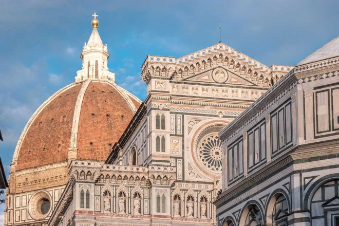 Close-up of the intricate facade and the grand dome of Florence's Cathedral of Santa Maria del Fiore, showcasing the architectural details and Renaissance artistry