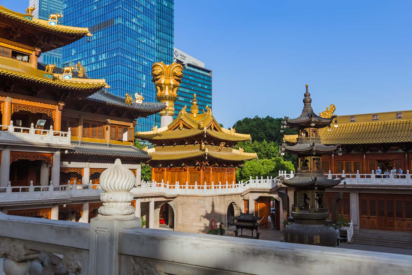 Jing'an Temple in Shanghai, contrasting ancient golden-roofed pavilions with the modern skyscrapers behind
