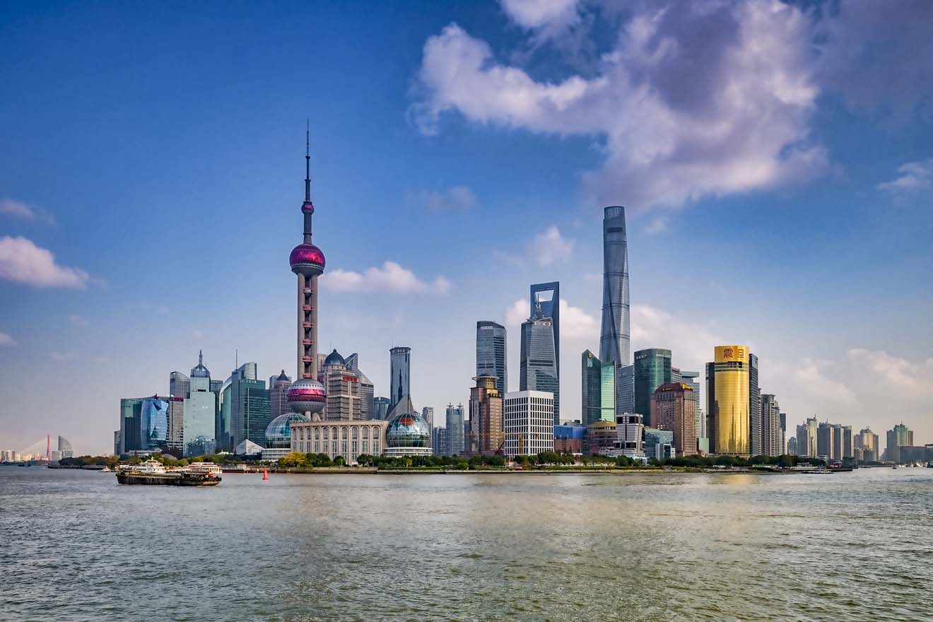 The Shanghai skyline with iconic Oriental Pearl Tower and skyscrapers along the Huangpu River on a clear day