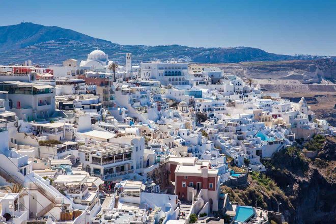 A view of the white buildings in santorini, greece.