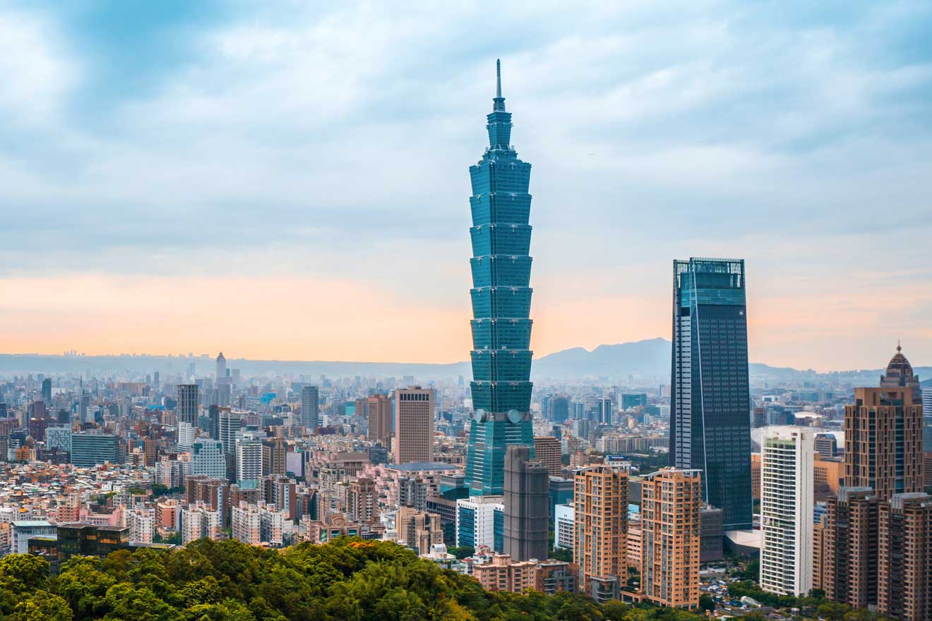 View of Taipei 101 towering over the cityscape against a dusky sky in Taipei, Taiwan