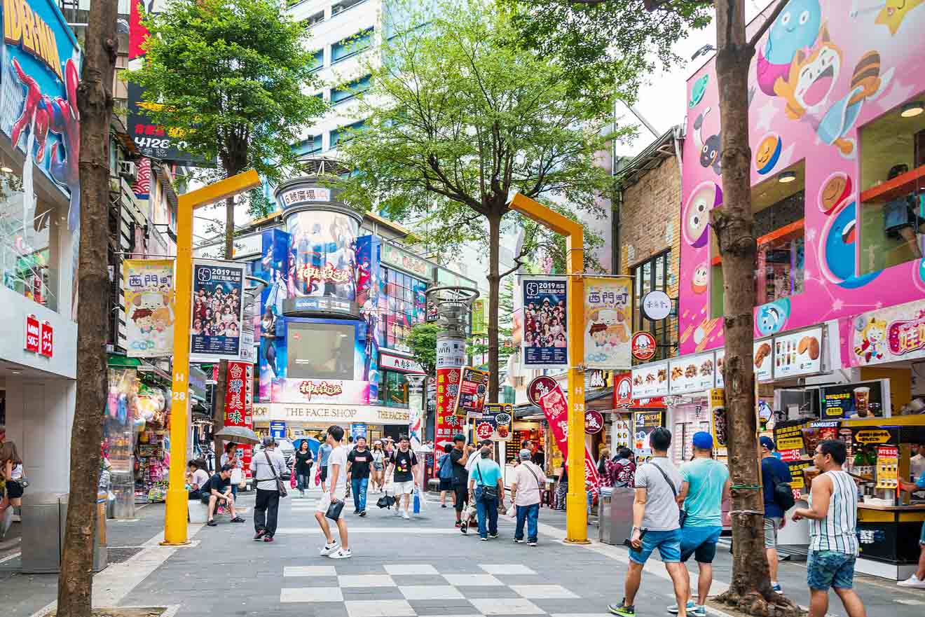 Pedestrian street in Taipei lined with vibrant shopfronts and bustling with shoppers