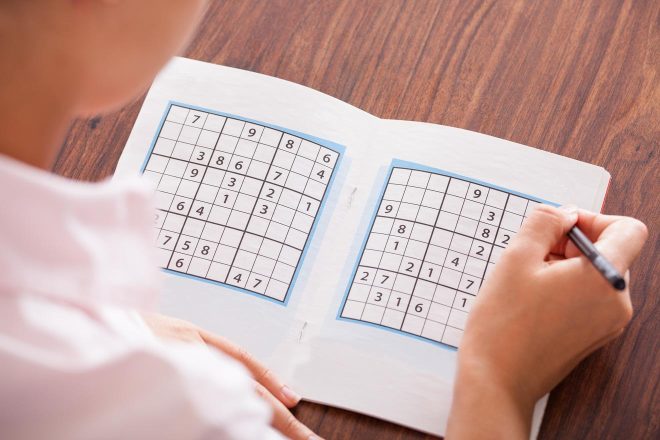 woman solving sudoku