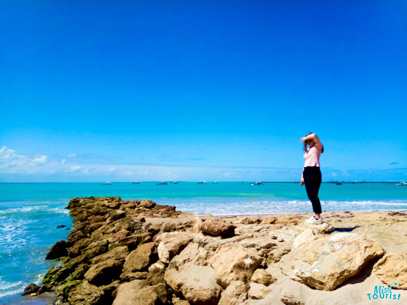 a person standing on a rocky beach