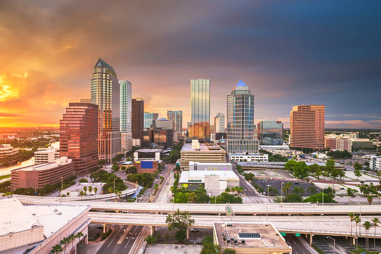 Scenic view of Tampa skyline during sunset with dramatic clouds and vibrant colors