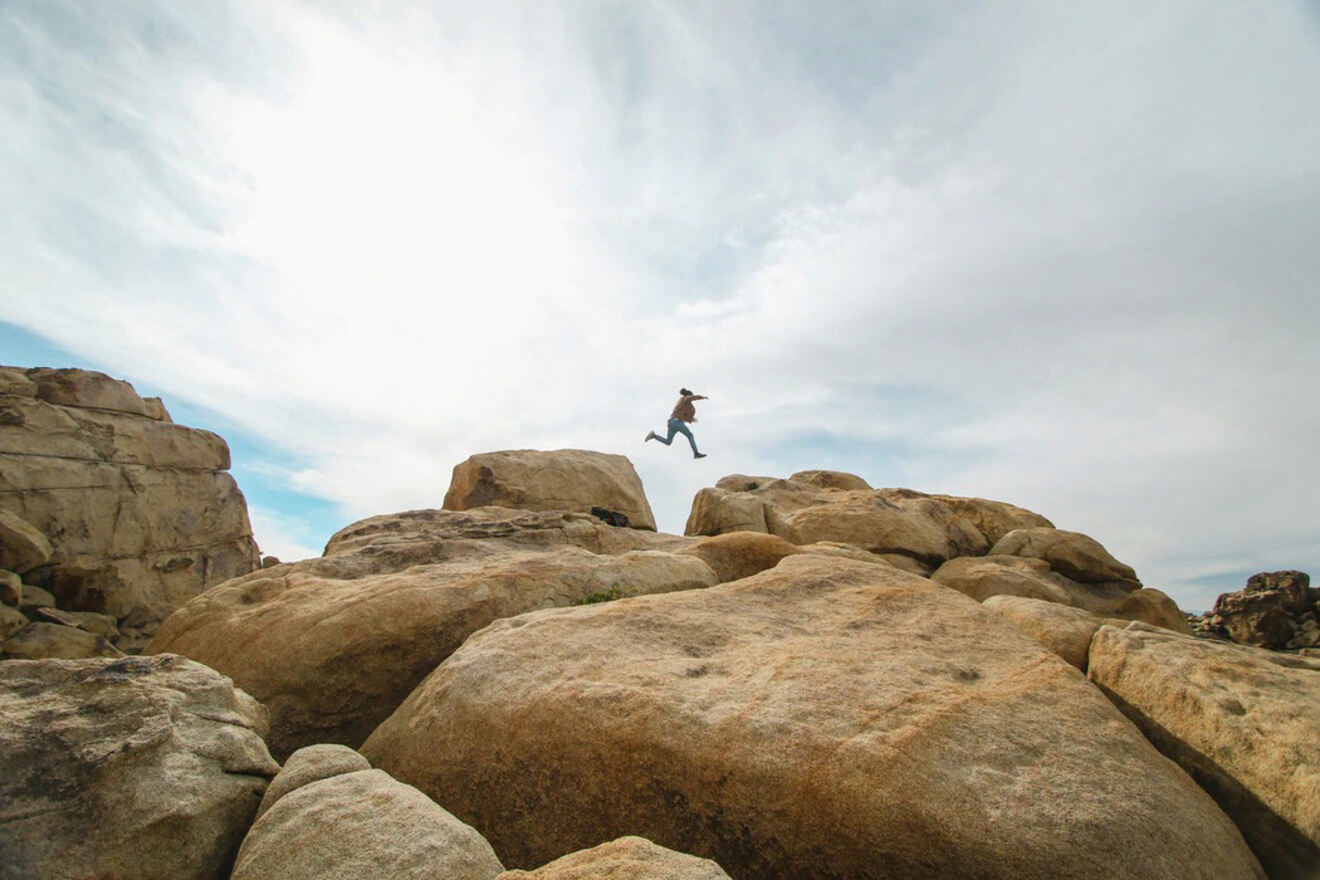 A person jumping on rocks