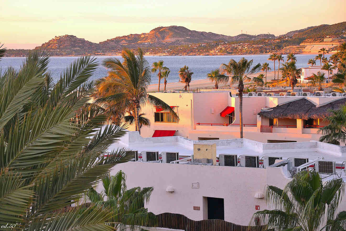 Twilight over a luxurious resort with palm trees and a scenic view of the ocean in Los Cabos, Mexico.