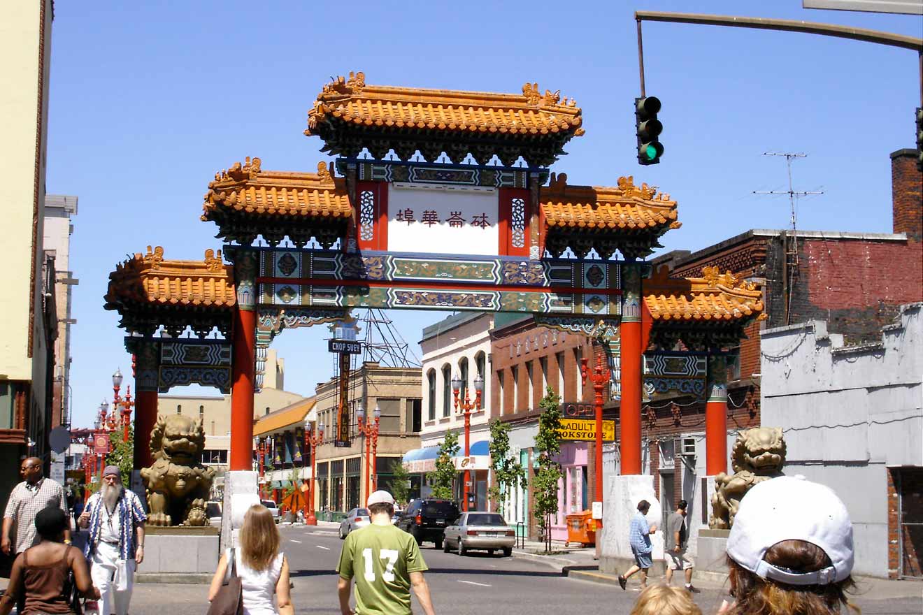 Portland's ornate Chinatown gate with pedestrians walking by in daylight