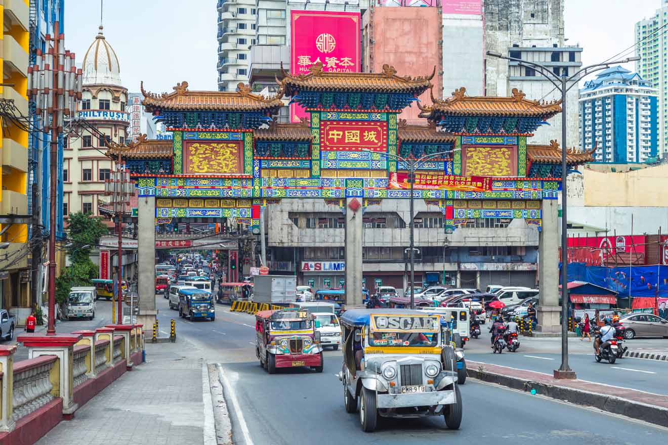 Vibrant and bustling street scene at the entrance of Manila's Chinatown with colorful arches and traditional jeepneys