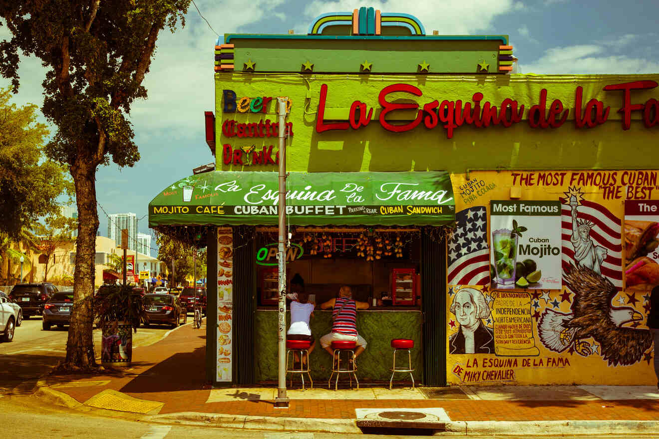 Colorful façade of 'La Esquina de la Fama', a famous Cuban café in Miami with outdoor seating and vibrant street art.