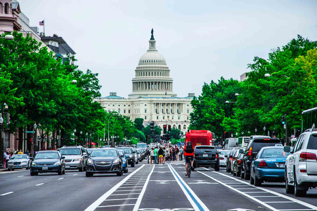 A bustling city street leading towards the U.S. Capitol building in Washington D.C., highlighted by the rays of the setting sun.
