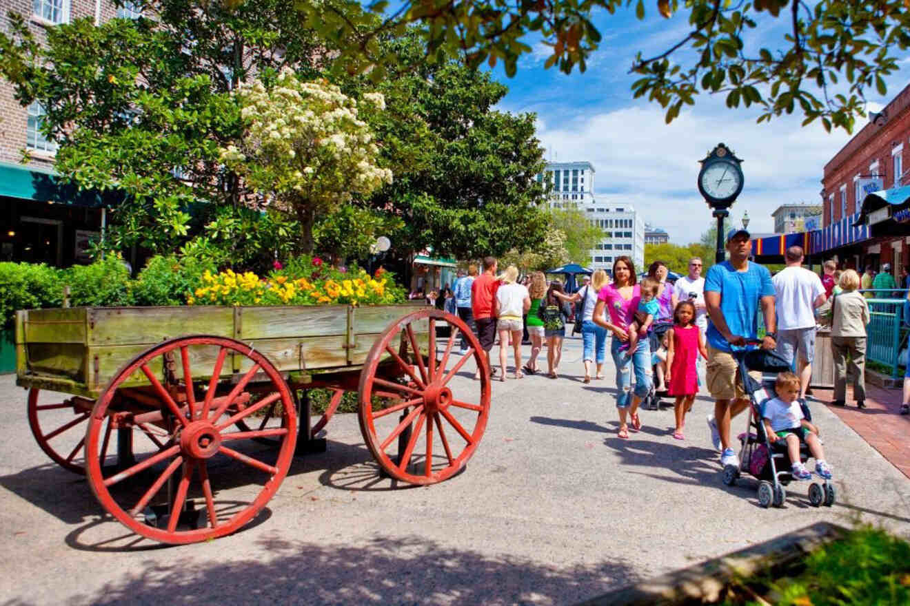 Busy city street scene with families walking past a historic flower cart under sunny skies.