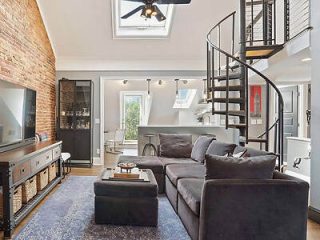 A living room with a spiral staircase.