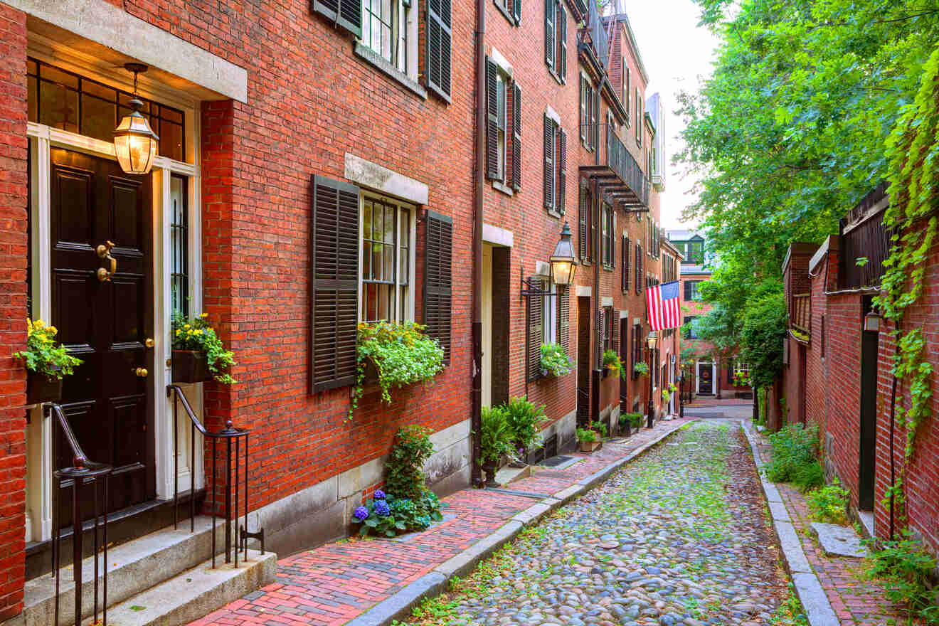 a cobbled street with buildings made of red bricks