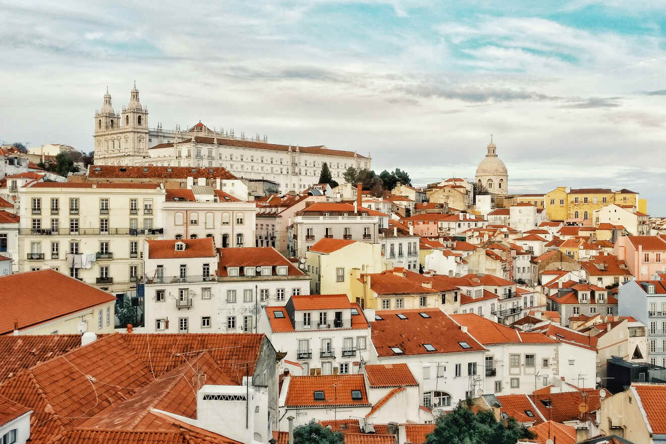 Scenic view of Lisbon's historic architecture with the São Vicente de Fora monastery prominently visible among the terracotta rooftops