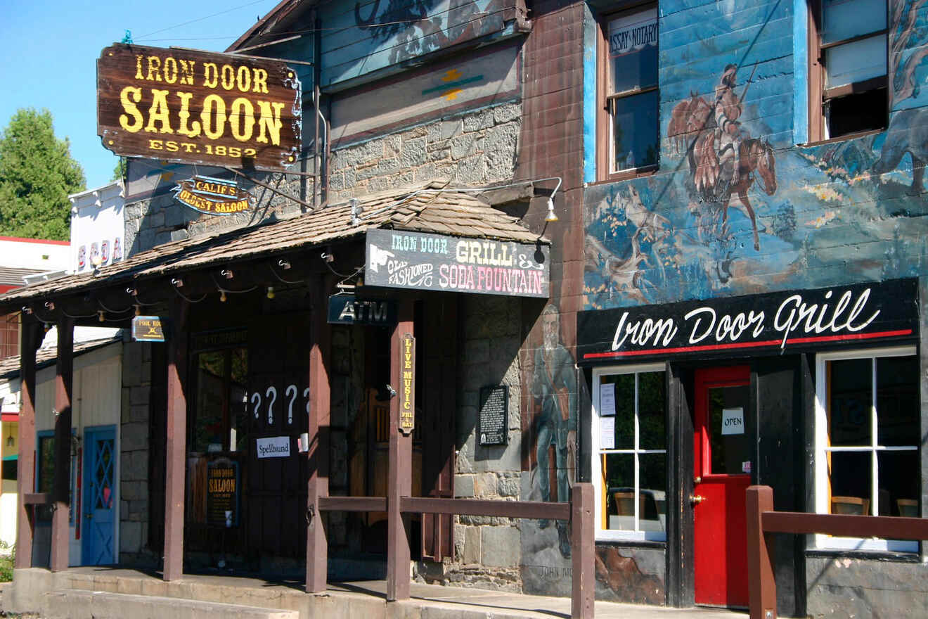 The iconic Iron Door Saloon, established in 1852, with a rustic façade and murals depicting western scenes.
