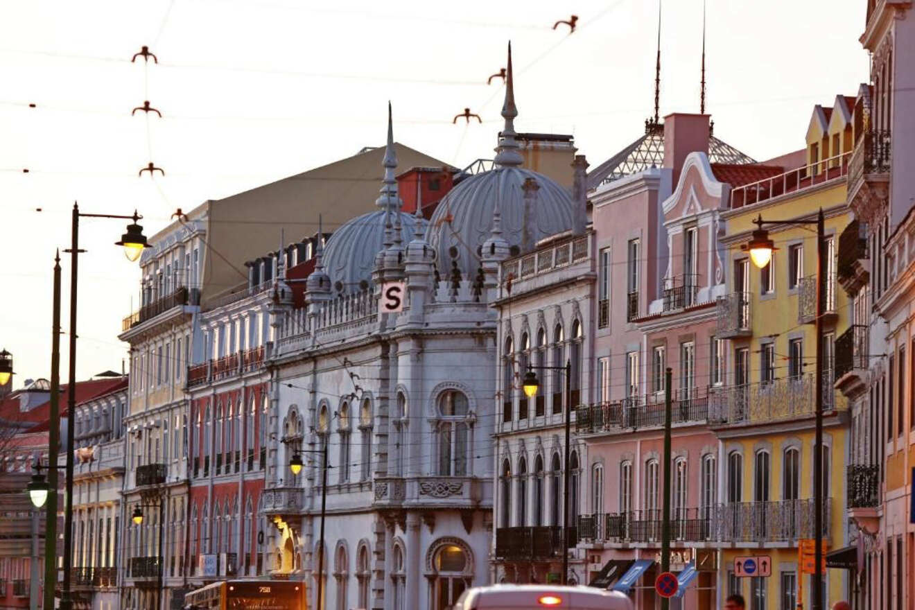 Twilight over Lisbon streets showcasing the grandeur of the Rossio Railway Station with its distinctive architecture and façades