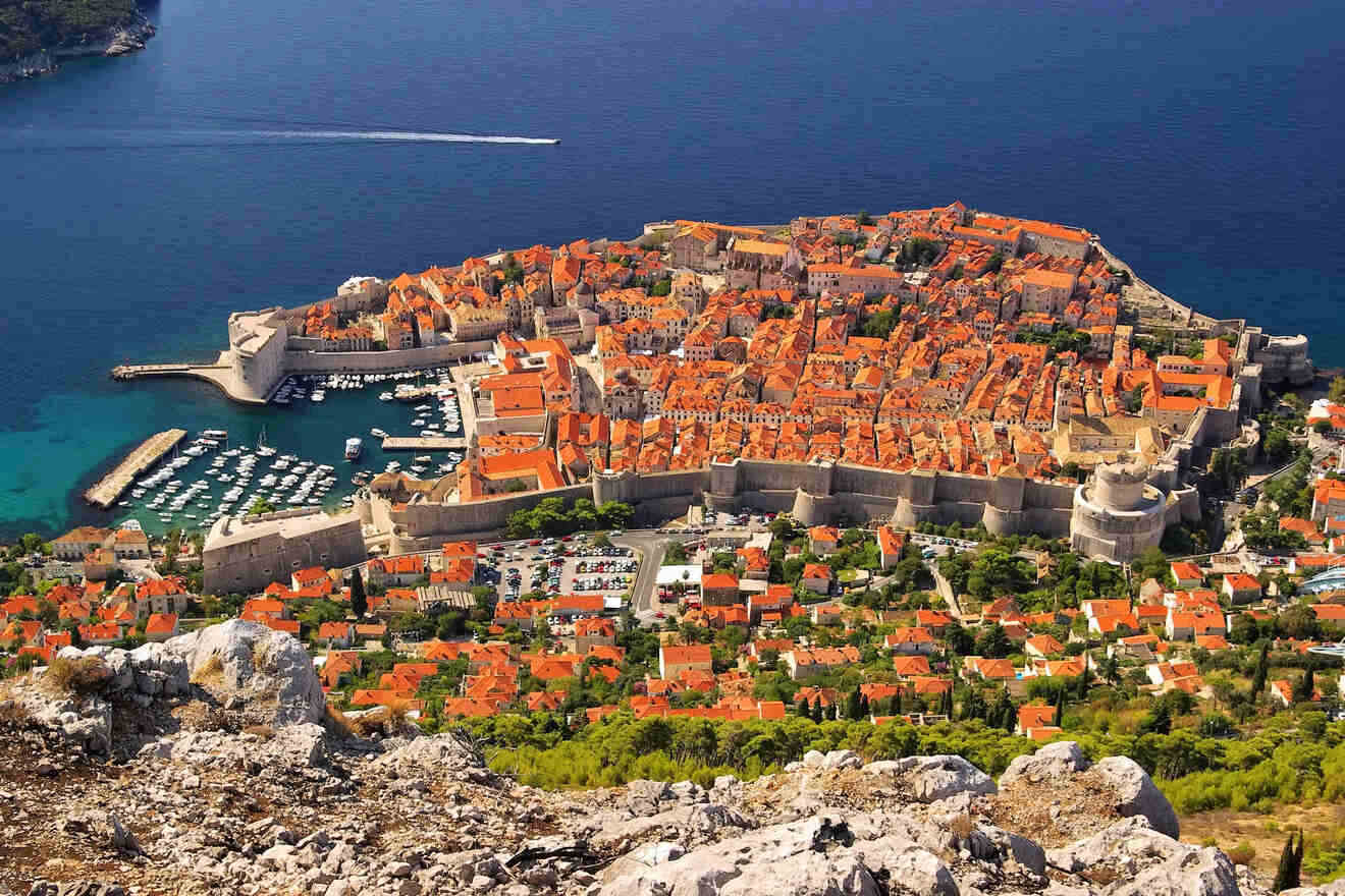 Aerial view of Dubrovnik's old town, showcasing terracotta rooftops, medieval walls, and the Adriatic Sea