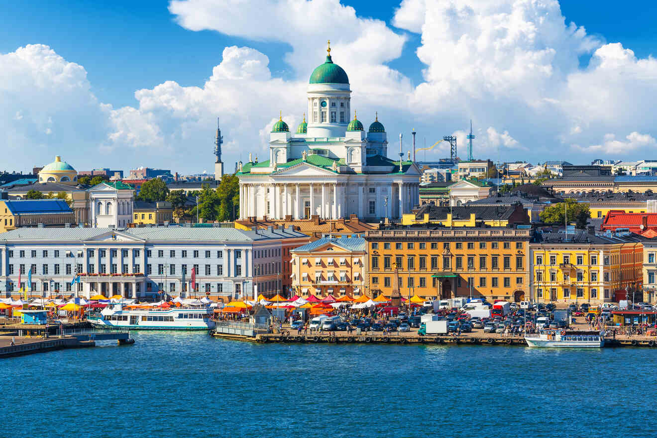 View of Helsinki skyline showcasing the Helsinki Cathedral, vibrant market stalls by the harbor, and boats docked along the pier on a sunny day