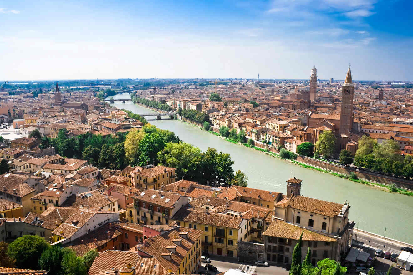 A vibrant aerial view of Verona, Italy, highlighting the city's architecture, the Adige River, and clear blue skies.
