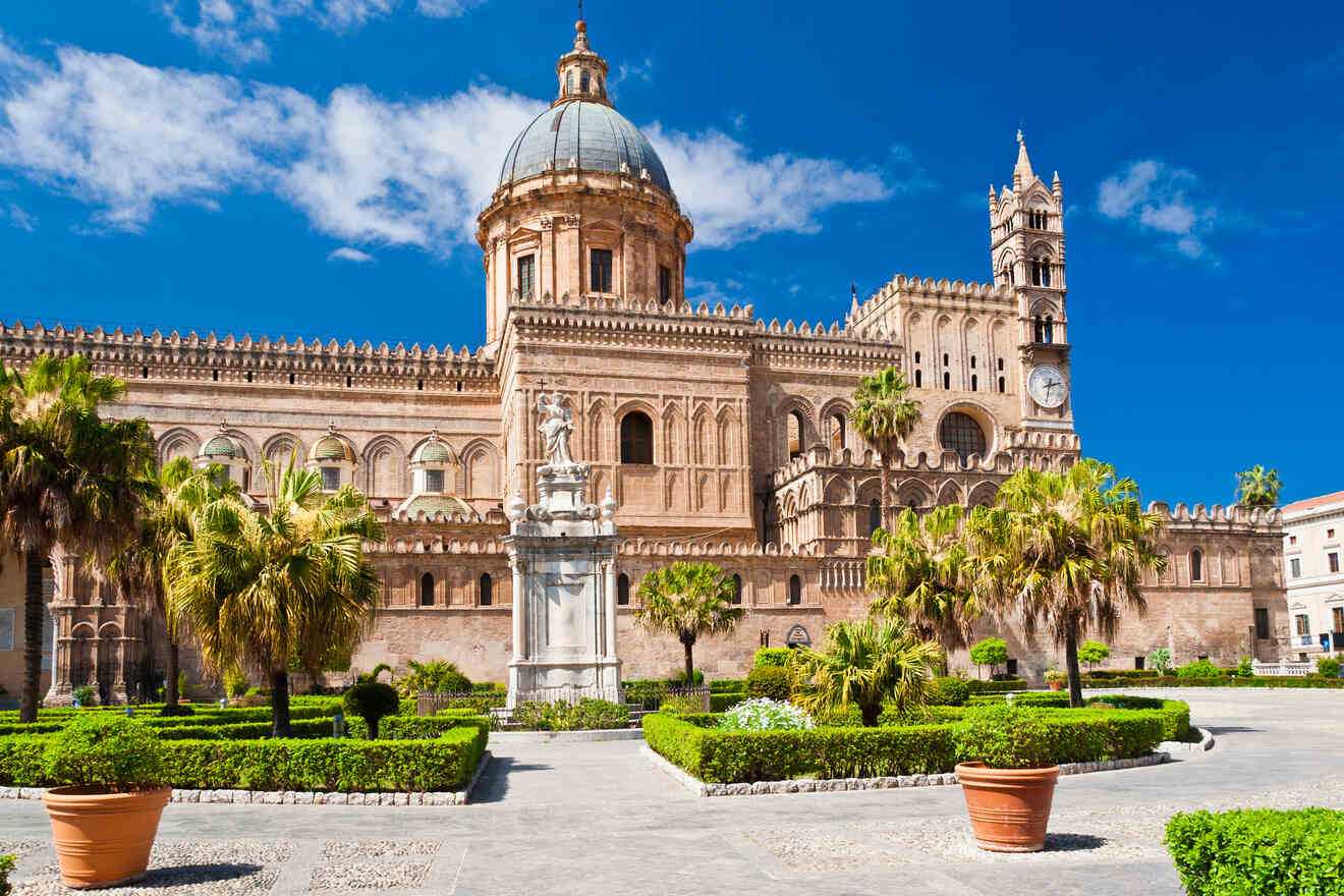 An ornate building with palm trees in front of it.