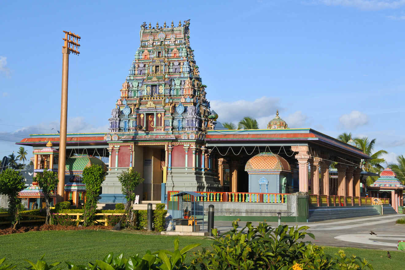 A vibrant Hindu temple adorned with intricate sculptures and colorful decorations under a clear blue sky
