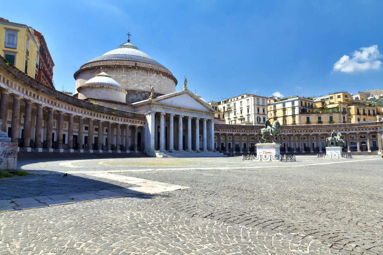 A view of a square with columns and a dome in Piazza del Plebiscito in Naples, Italy.