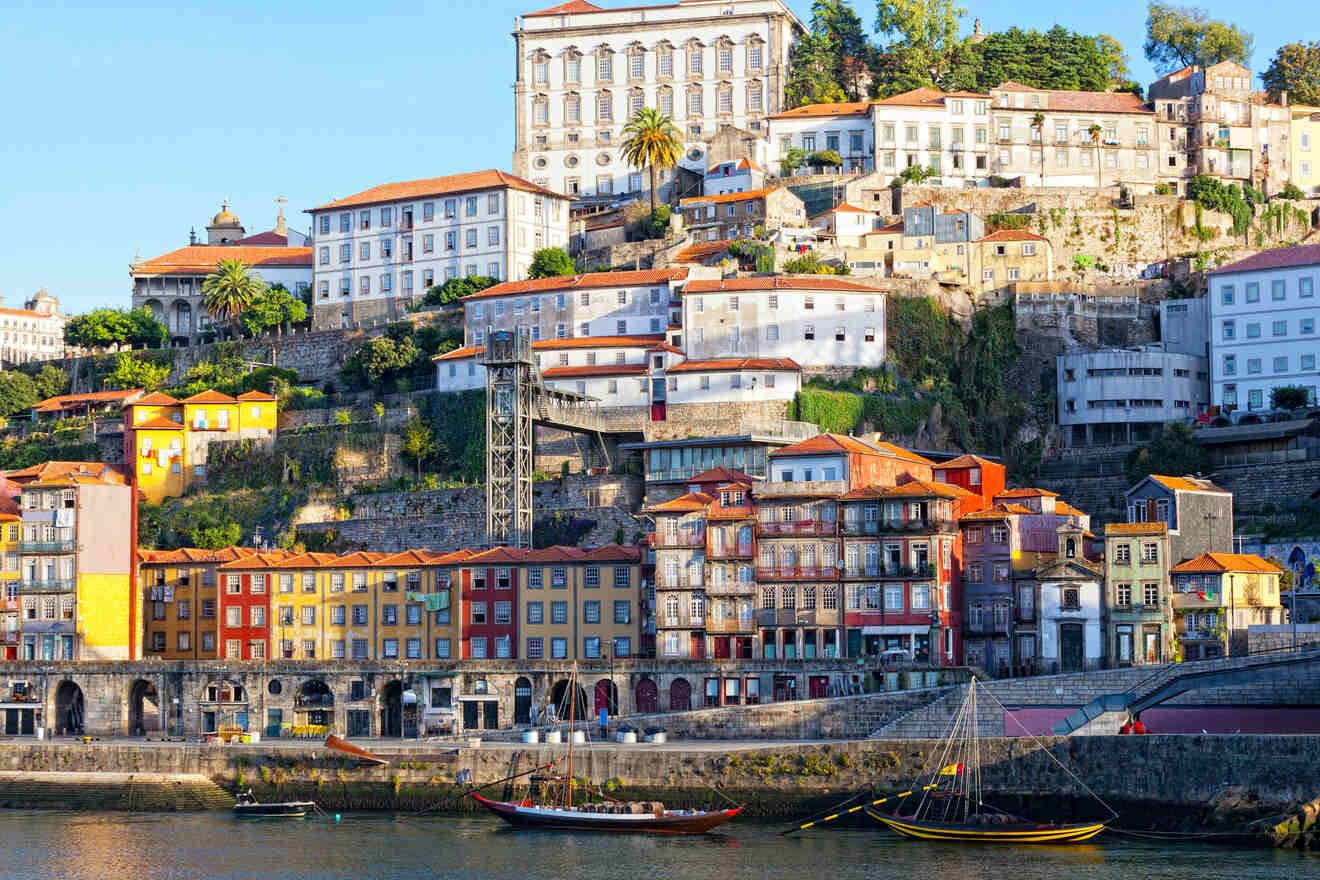 Sunset view of Vila Nova de Gaia in Porto, Portugal, with its terraced houses and historic buildings cascading down to the Douro River's edge