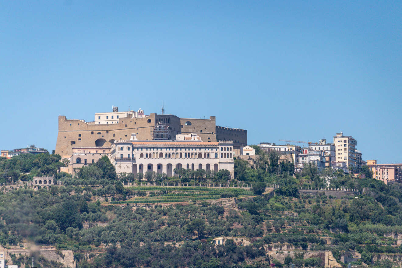 An old castle sits on top of a hill in Naples.