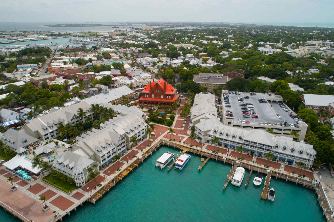 Aerial view of Key West, Florida, showing a mix of residential and commercial areas with a prominent red-roofed building near the waterfront