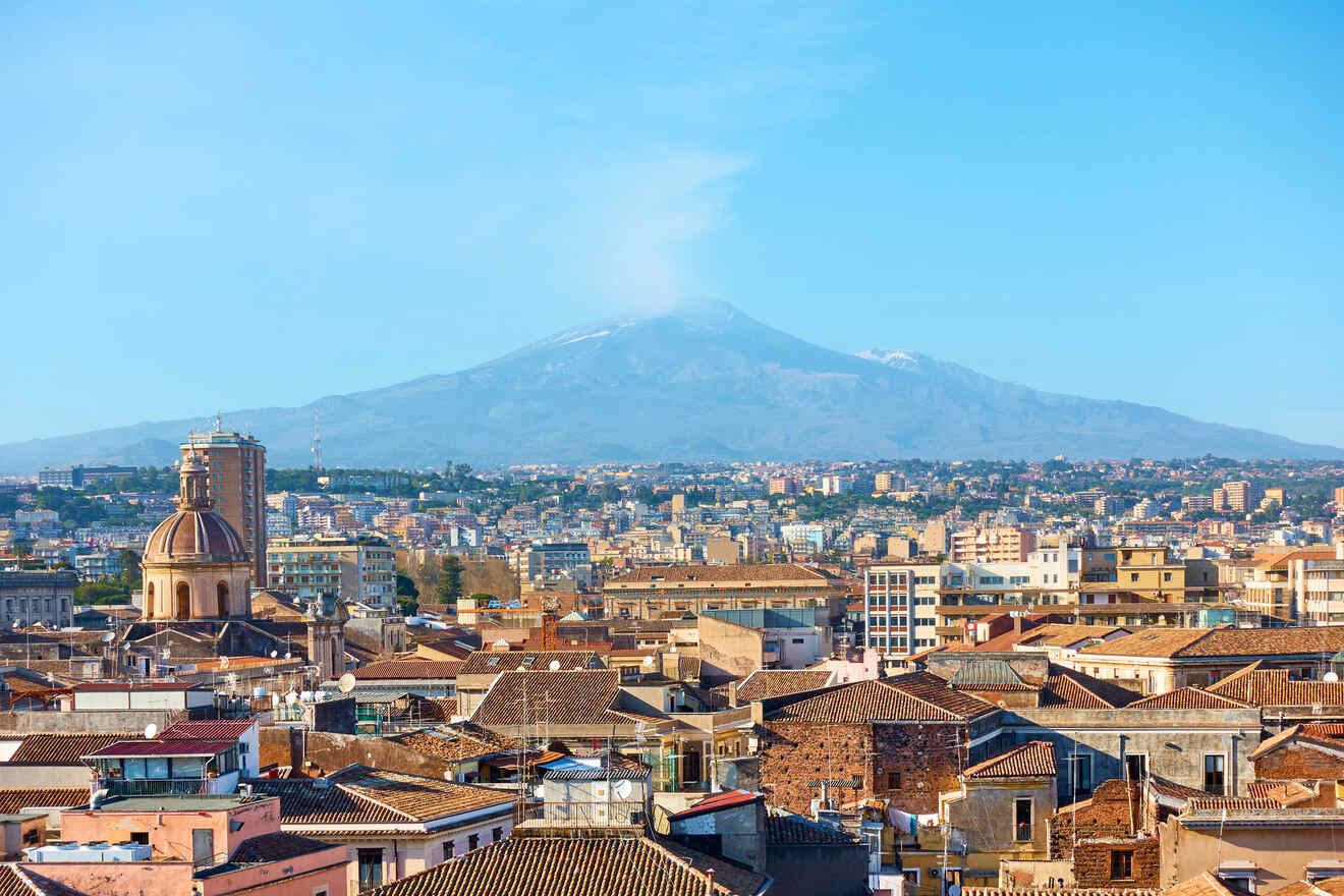 A view of a city with a volcano in the background.