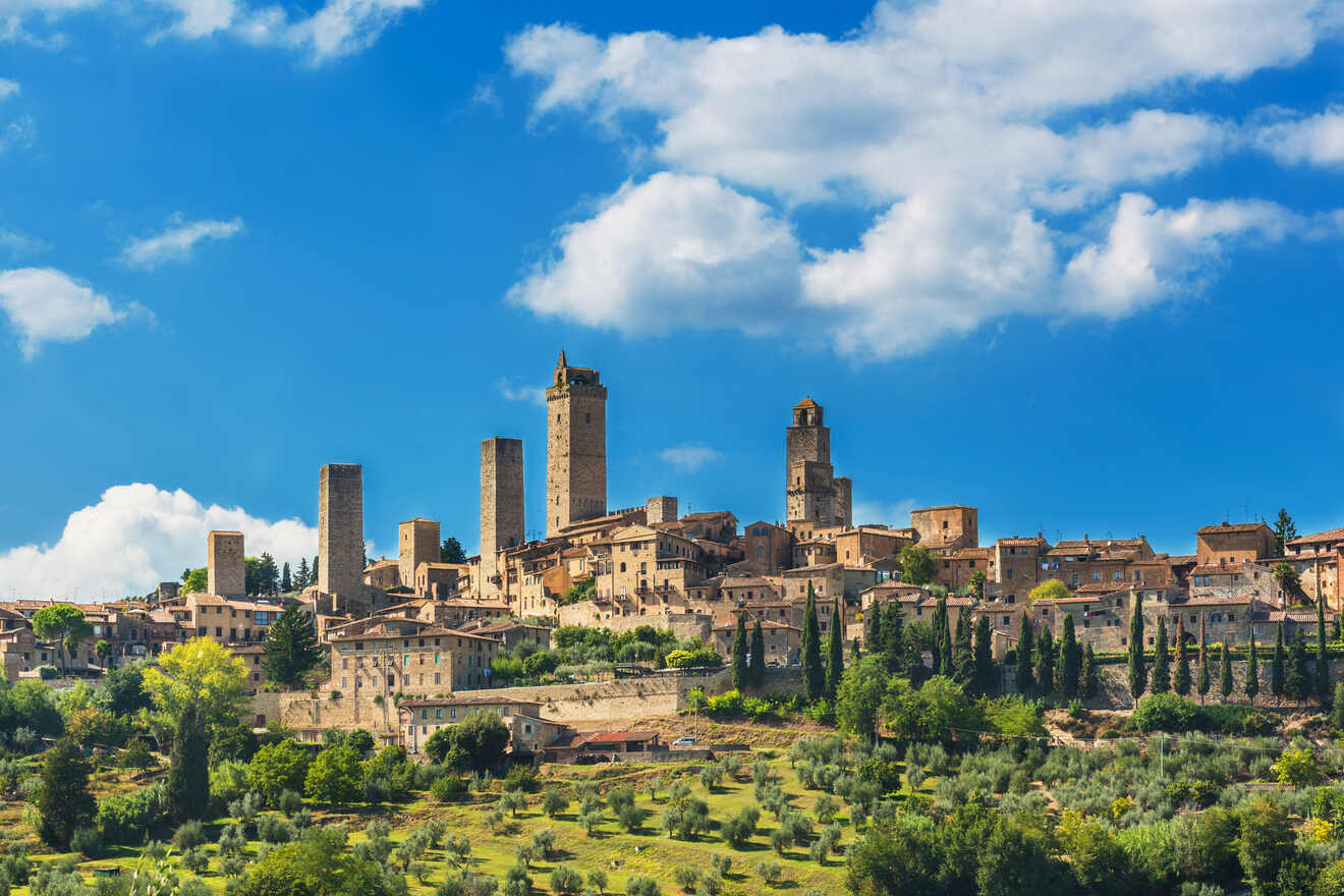 Historic skyline of San Gimignano, Italy, with its famous medieval towers set amidst rolling Tuscan hills, under a dynamic sky with scattered clouds