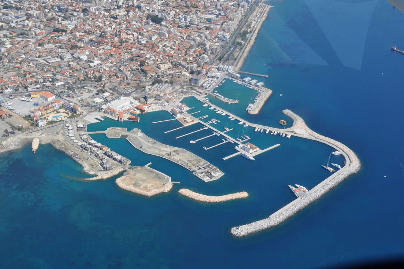 Aerial view of a coastal town in Cyrpus with detailed marina layout, showcasing the orderly beauty of a Mediterranean port