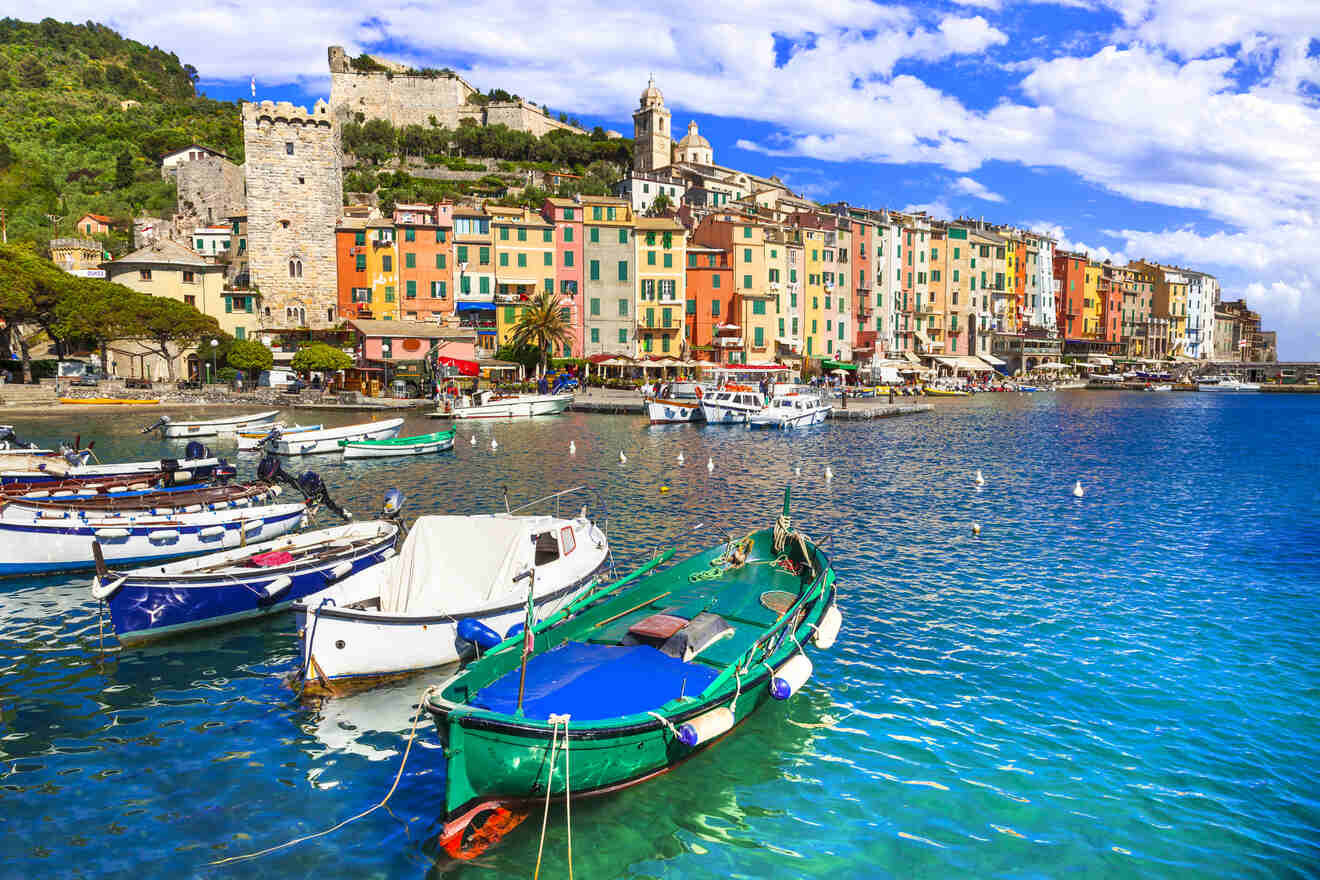 Picturesque view of Portovenere's waterfront lined with multicolored houses and boats, encapsulating the quintessential charm of the Ligurian coast.