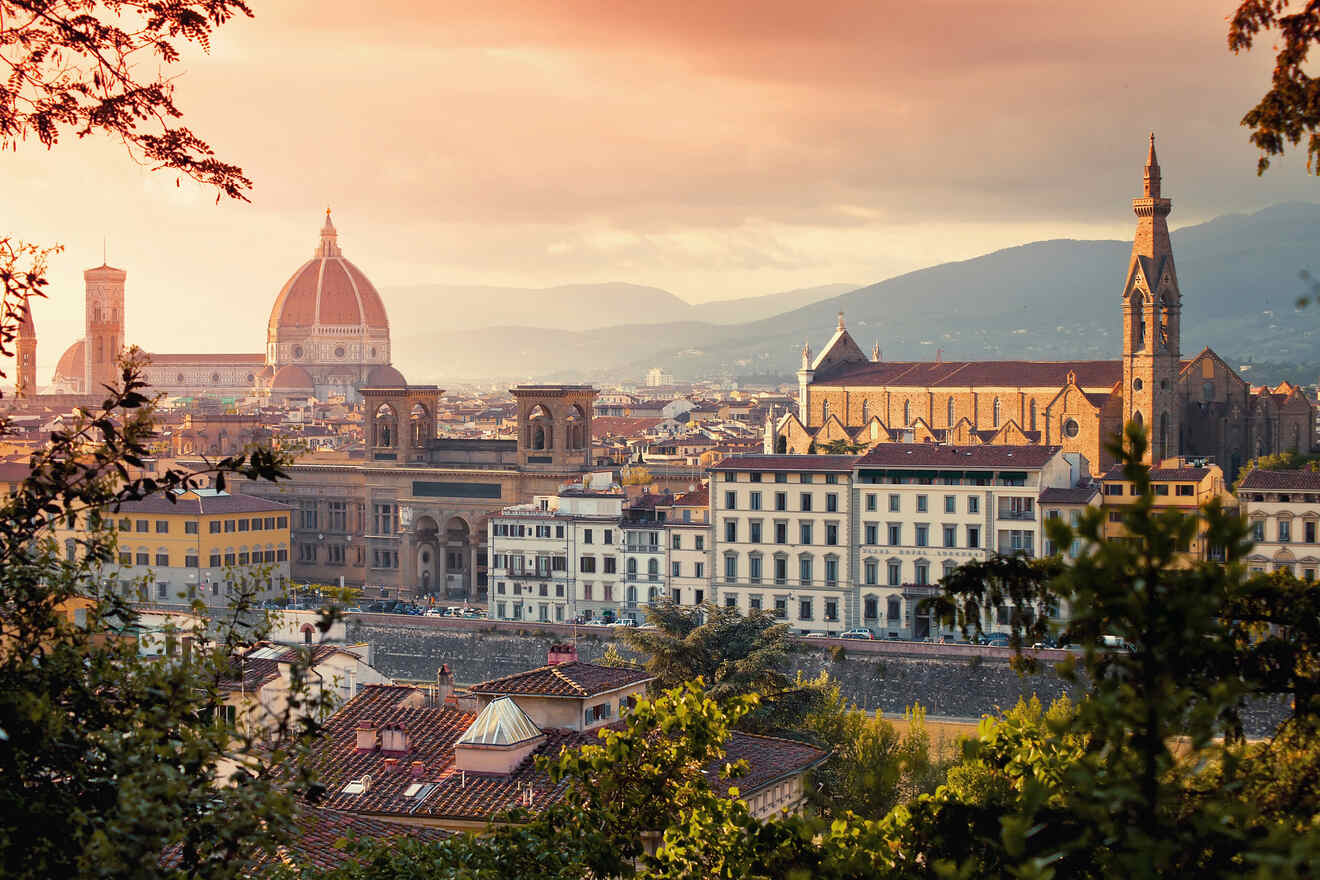 Florence's cityscape glows in the warm light of dusk with the historic Duomo standing tall, as viewed through the silhouette of trees, illustrating the romantic allure of Italian sunsets