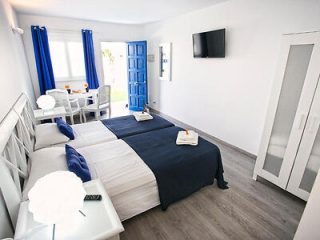 Hotel room interior with blue decor and balcony